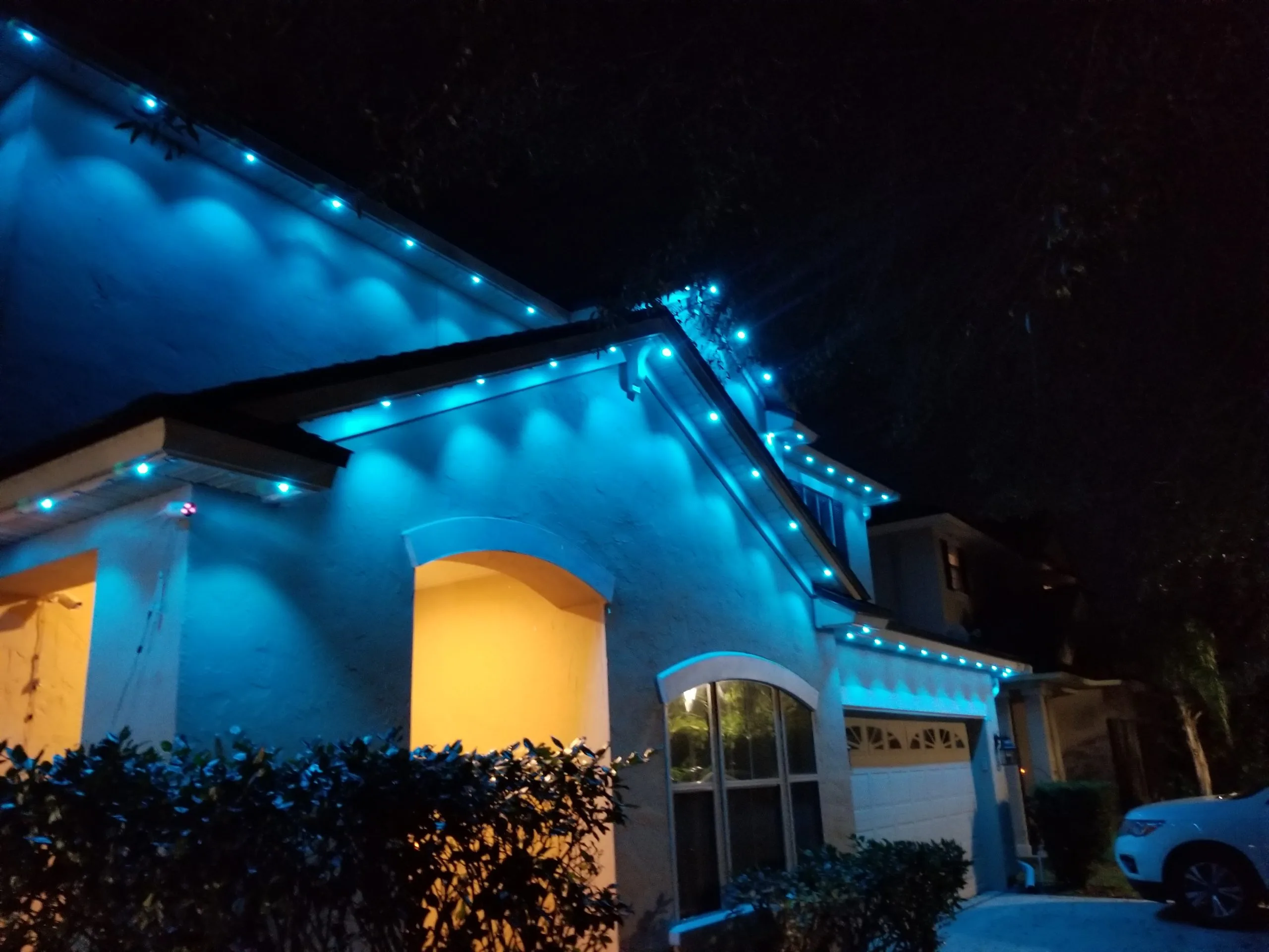 LED outdoor lighting in St. Augustine highlights a house with vibrant blue illumination at night