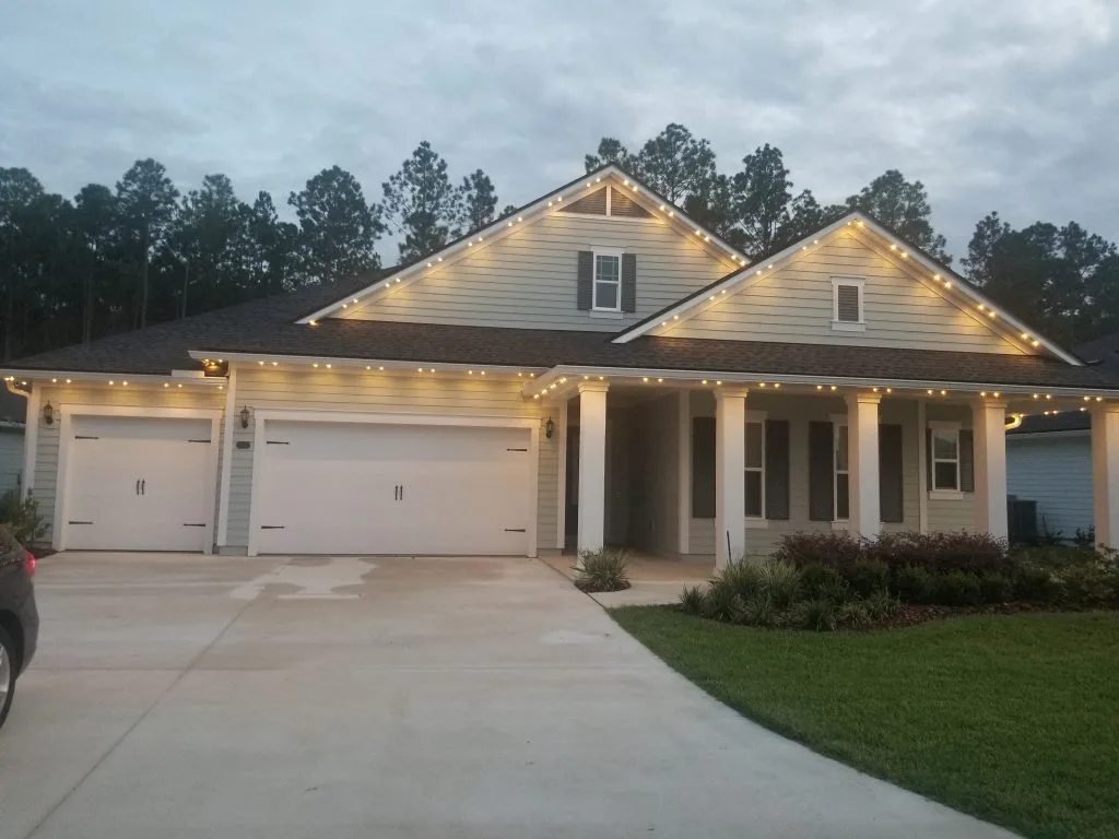 Architectural lighting enhances the charm of a house against a twilight sky