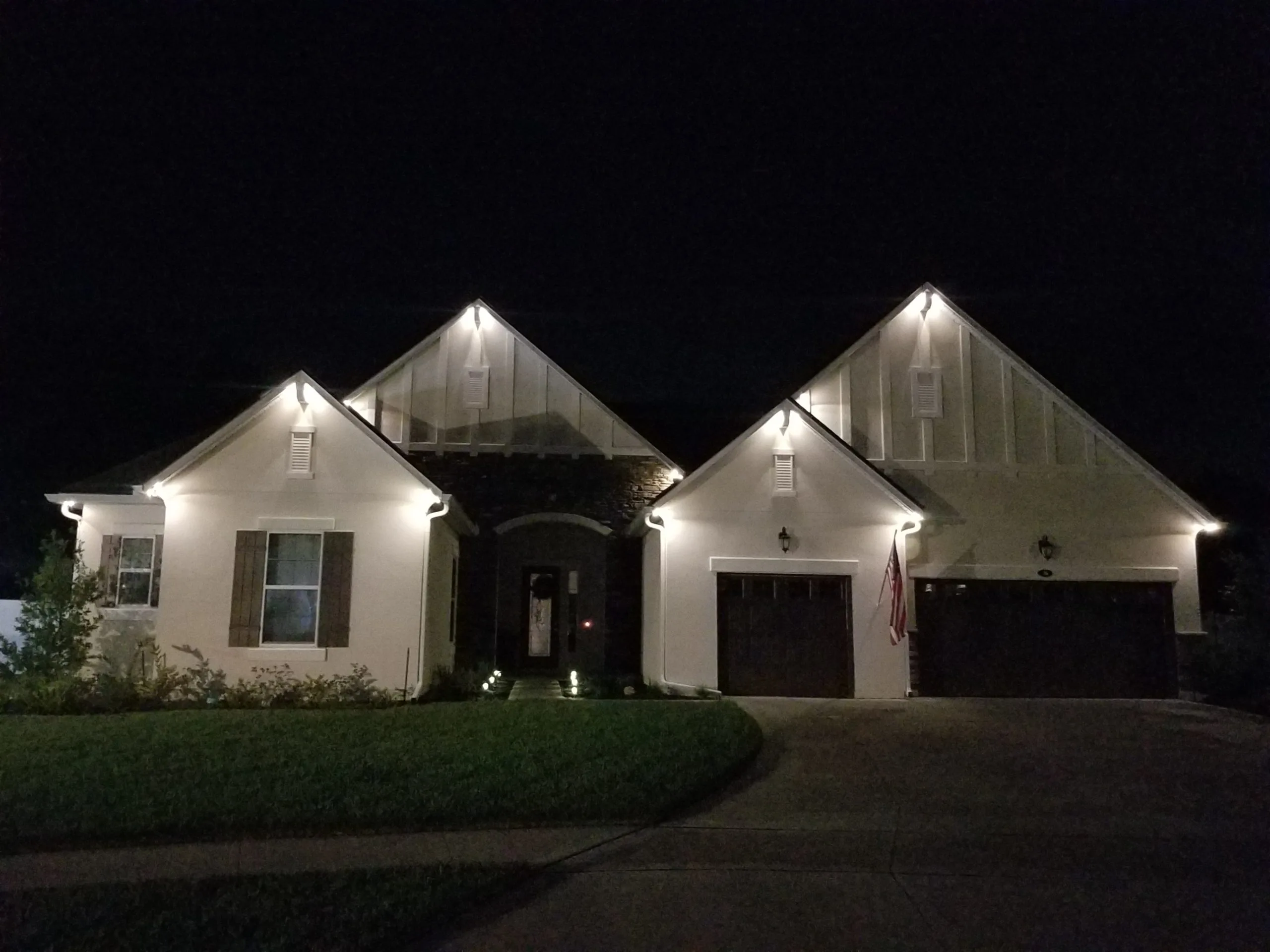 A beautifully lit house shines warmly under the night sky