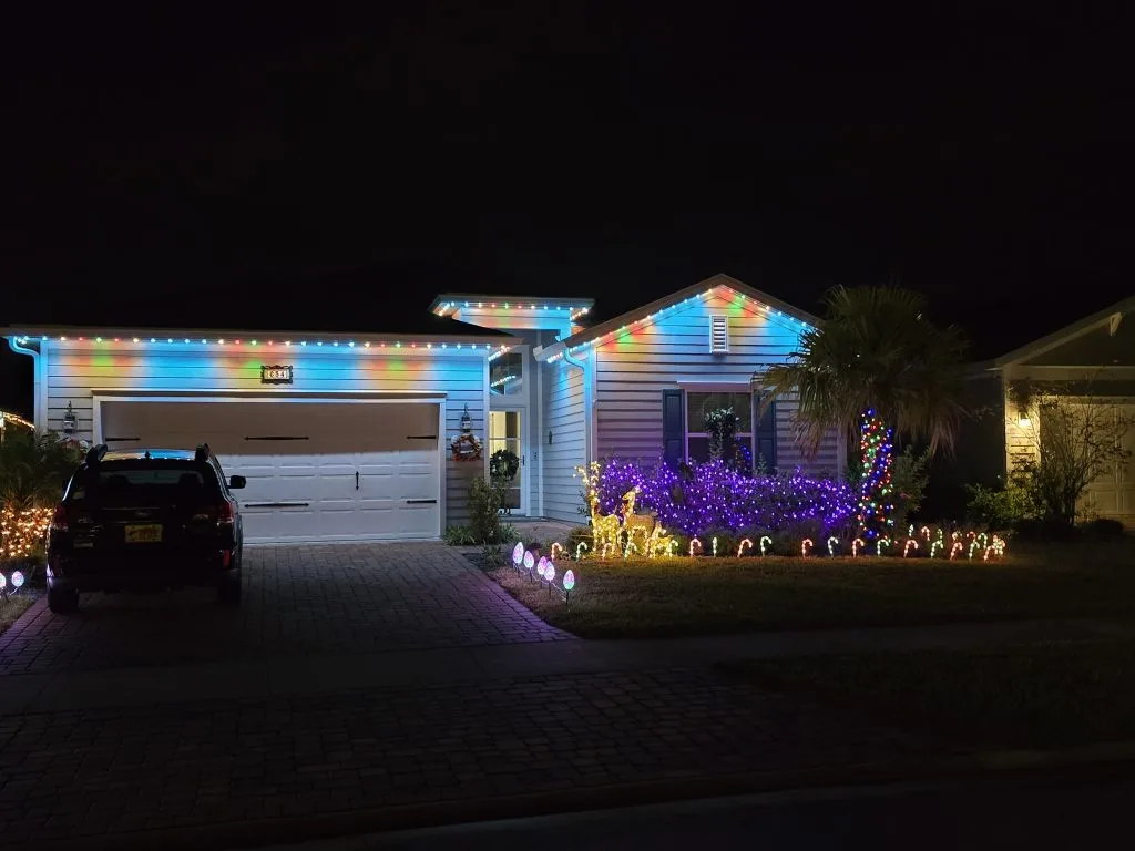 Trim lighting enhances the festive atmosphere of a beautifully decorated house at night