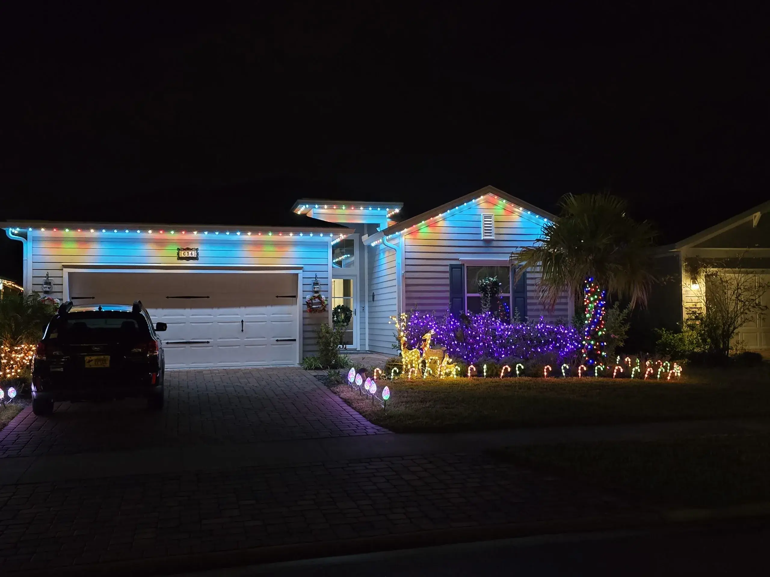 Trim lighting enhances the festive atmosphere of a beautifully decorated house at night