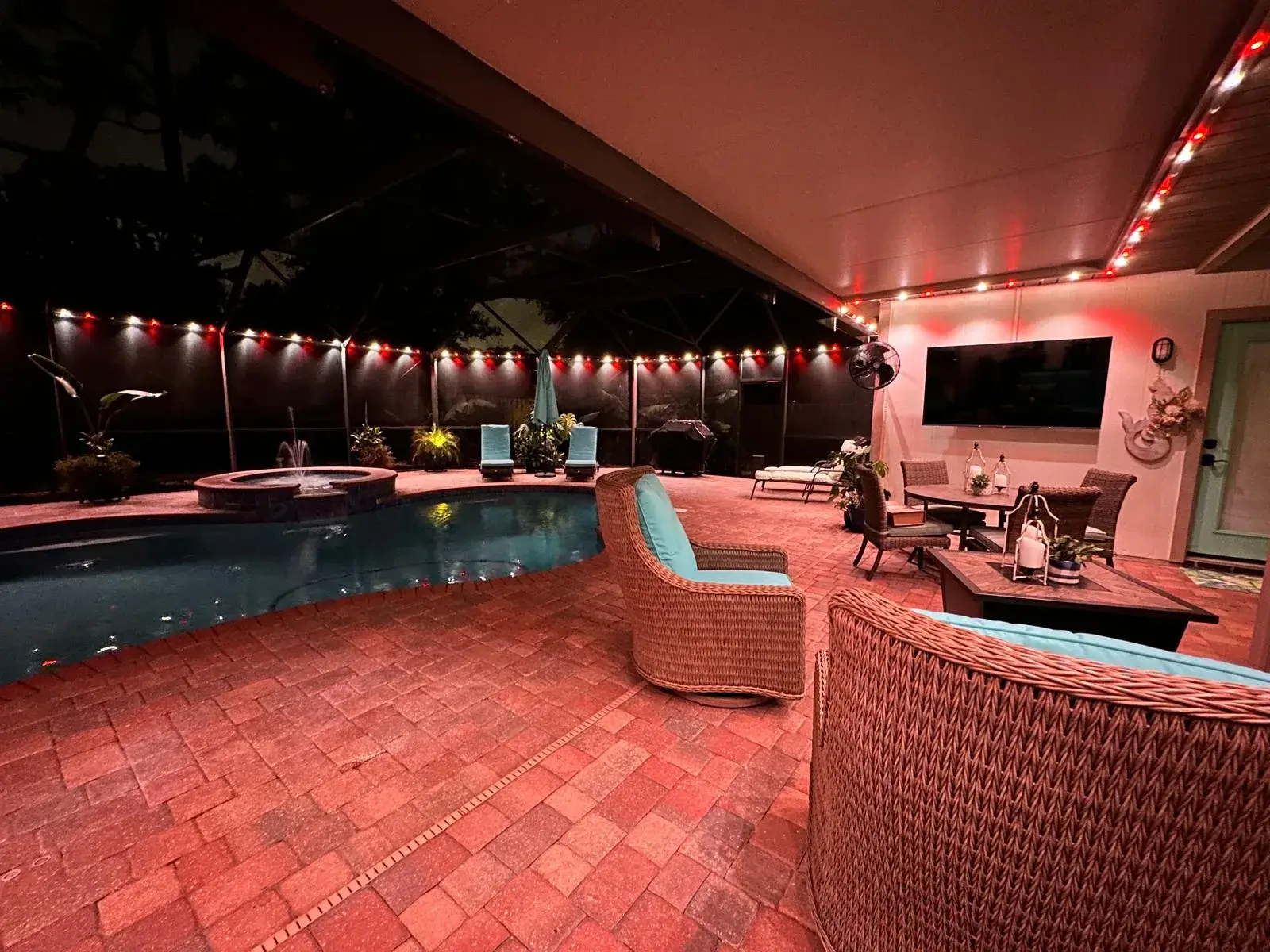 Holiday lighting installation in St. Augustine enhances a stylish outdoor patio with decorative lights and cozy seating