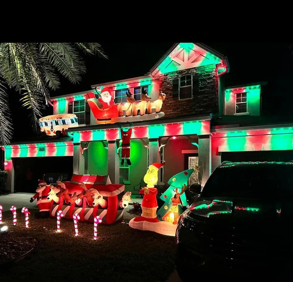 Holiday lighting installation in St. Augustine brightens a home with festive lights and inflatable figures